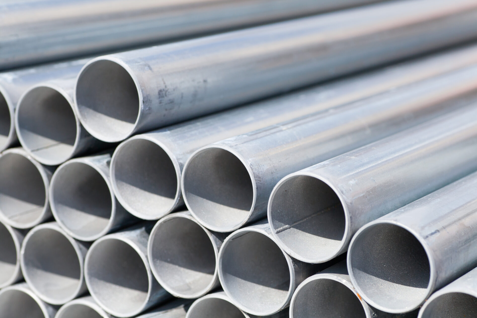close up stack of construction metal pipes